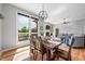 Well-lit dining room features a wooden table, modern light fixture, and views to the backyard at 2015 Saint Andrews Ct, Franklin, IN 46131