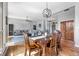 Open-concept dining room showcases a wooden table, stylish light fixture, and seamless flow into the cozy living area at 2015 Saint Andrews Ct, Franklin, IN 46131