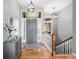 The home has a welcoming foyer with wood floors, a gray front door, and a staircase at 2015 Saint Andrews Ct, Franklin, IN 46131