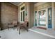 Cozy front porch with two chairs, brick accents, and a welcoming entrance at 2015 Saint Andrews Ct, Franklin, IN 46131