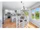 Open kitchen with an eat-in island, bright countertops, and a view to the outdoors at 2015 Saint Andrews Ct, Franklin, IN 46131