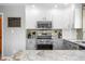 Well-lit kitchen features stainless steel appliances, white cabinets, granite countertops, and modern fixtures at 2015 Saint Andrews Ct, Franklin, IN 46131