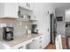 Stylish kitchen with white cabinets, granite countertops, built-in desk and modern stainless steel appliances at 2015 Saint Andrews Ct, Franklin, IN 46131