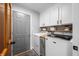Well-lit laundry room with white cabinets, modern washer and dryer, and ample storage space at 2015 Saint Andrews Ct, Franklin, IN 46131