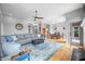 Open-concept living area featuring a spacious sectional sofa, area rug, and connection to the dining area at 2015 Saint Andrews Ct, Franklin, IN 46131