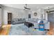 Bright living area with a large sectional couch, area rug, and a view of the entryway and hallway at 2015 Saint Andrews Ct, Franklin, IN 46131