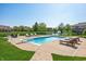 Sparkling in-ground pool with diving board, basketball hoop and lounge chairs overlooking a pond at 2015 Saint Andrews Ct, Franklin, IN 46131