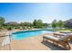 An inviting backyard pool has lounge chairs and is set against a backdrop of mature trees and a tranquil pond at 2015 Saint Andrews Ct, Franklin, IN 46131