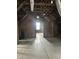 Unfinished attic space with exposed wooden beams and a window at 2119 S Garfield Dr, Indianapolis, IN 46203