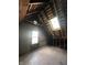 Spacious attic with skylight and wooden floors, offering potential for renovation at 2119 S Garfield Dr, Indianapolis, IN 46203
