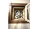 Attic fan unit with an aged, vintage design, including a wooden frame and a protective metal grill at 2119 S Garfield Dr, Indianapolis, IN 46203