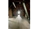 Large unfinished attic space, showcasing exposed beams and a window view at 2119 S Garfield Dr, Indianapolis, IN 46203