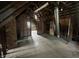 Spacious unfinished attic with exposed beams, brick chimney, and natural light at 2119 S Garfield Dr, Indianapolis, IN 46203