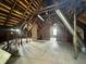 Large unfinished attic with exposed beams, perfect for customization and storage at 2119 S Garfield Dr, Indianapolis, IN 46203
