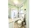 Bathroom with mint green paint, white bathtub and tile, and a window at 2119 S Garfield Dr, Indianapolis, IN 46203