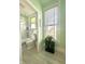 Bathroom with mint green paint, a black plant stand, and a window at 2119 S Garfield Dr, Indianapolis, IN 46203