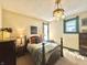 Bedroom with a wood bed frame, overhead lighting, and neutral colored walls at 2119 S Garfield Dr, Indianapolis, IN 46203