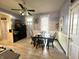Bright dining area with a table and chairs, wooden floors, and white trimmed door and windows at 2119 S Garfield Dr, Indianapolis, IN 46203