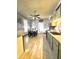 Dining area features light wood-look floors, a ceiling fan, and is decorated with vintage wall art at 2119 S Garfield Dr, Indianapolis, IN 46203