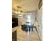 Dining area features light wood-look floors, a ceiling fan, and vintage wall decor and framed windows at 2119 S Garfield Dr, Indianapolis, IN 46203