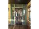 Elegant entryway with glass paneled doors, showcasing stylish decor and a glimpse into the living spaces at 2119 S Garfield Dr, Indianapolis, IN 46203