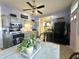 Kitchen featuring updated gray cabinets, modern black appliances, and view to kitchen table at 2119 S Garfield Dr, Indianapolis, IN 46203