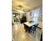 Open kitchen with gray cabinets, black appliances, and light wood-look floors leading to dining area at 2119 S Garfield Dr, Indianapolis, IN 46203