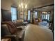 Inviting living room features a decorative chandelier, windows with blinds, and an open entryway at 2119 S Garfield Dr, Indianapolis, IN 46203