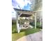 Backyard oasis featuring a charming pergola with seating and turf at 2119 S Garfield Dr, Indianapolis, IN 46203
