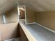 An attic with finished floors and neutral paint at 2271 Park Ave, Columbus, IN 47201