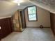 Finished attic with a window and carpeted floors, offering potential for extra living space at 2271 Park Ave, Columbus, IN 47201