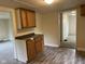 A modest kitchen with wood cabinets and laminate floors at 2271 Park Ave, Columbus, IN 47201