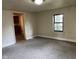 Inviting living room featuring neutral paint, carpeting, and a window bringing in natural light at 2271 Park Ave, Columbus, IN 47201