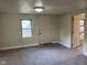 Cozy living room with neutral tones, new carpeting and window allowing natural light to flow through at 2271 Park Ave, Columbus, IN 47201