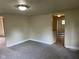 Spacious living area featuring new carpeting, neutral walls and a large window at 2271 Park Ave, Columbus, IN 47201
