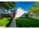 Well-maintained backyard with green lawn, a detached garage, and clear blue skies at 2306 Alabama St, Indianapolis, IN 46205