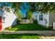 Landscaped backyard featuring green grass and privacy fence between neighboring homes under a sunny, blue sky at 2306 Alabama St, Indianapolis, IN 46205