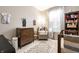 Bright Bedroom featuring a crib, changing table, bookshelf, and a comfortable armchair near natural lighting at 2306 Alabama St, Indianapolis, IN 46205