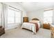 Bedroom with vaulted ceiling, two windows, neutral carpet, and wooden dresser at 2306 Alabama St, Indianapolis, IN 46205