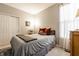 Cozy bedroom with a comfortable bed, patterned rug and ample natural light from the sheer-curtained window at 2306 Alabama St, Indianapolis, IN 46205