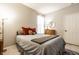 Neutral toned bedroom with natural lighting with comfy bed, dresser, and decorative wall mirror at 2306 Alabama St, Indianapolis, IN 46205