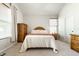 Bedroom with natural light, neutral carpet, wooden dresser, and coordinating nightstand at 2306 Alabama St, Indianapolis, IN 46205