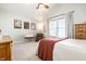 Bright bedroom featuring neutral walls, ceiling fan, carpet, and lots of natural light from a large window at 2306 Alabama St, Indianapolis, IN 46205