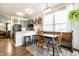 Eat-in kitchen with wooden table, chairs, bench, and sage colored cabinets at 2306 Alabama St, Indianapolis, IN 46205