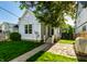 Charming home exterior with a well-manicured lawn, stone walkway, and inviting porch at 2306 Alabama St, Indianapolis, IN 46205