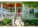 Inviting front porch with stained wood ceiling, white railings, and a charming red door at 2306 at 2306 Alabama St, Indianapolis, IN 46205