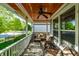 Relaxing front porch featuring comfortable seating and a stained wood ceiling with a ceiling fan at 2306 Alabama St, Indianapolis, IN 46205