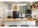 Bright kitchen featuring sage colored cabinets, butcher block counters, stainless appliances, and breakfast bar at 2306 Alabama St, Indianapolis, IN 46205