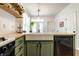 Kitchen sink area featuring sage colored cabinets, stainless appliances, and butcher block counters at 2306 Alabama St, Indianapolis, IN 46205
