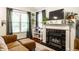 Inviting living room features a fireplace, hardwood floors, and large windows at 2306 Alabama St, Indianapolis, IN 46205